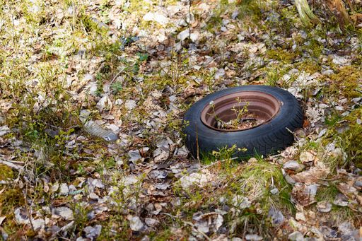 The Car tires and other trash dumped illegally along a road near Angvika, Norway.