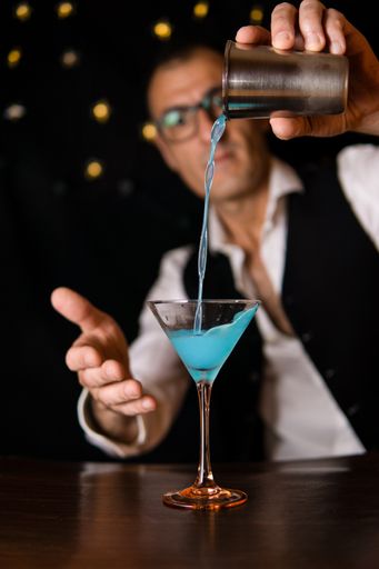 Close up view of a Barman making cocktails in a disco bar