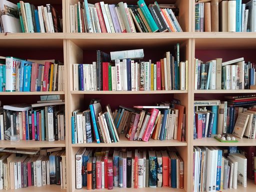 A closeup shot of many books on bookshelves in the library