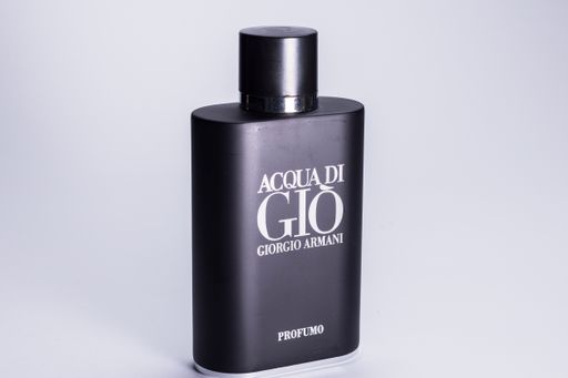 Black bottle of Giorgio's Agua di Gio cologne on a white background