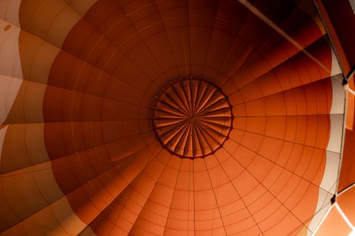 A low angle of the inner side of a vibrant orange air balloon- perfect for wallpapers