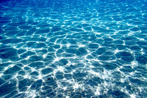 The sun rays penetrating through the pure sea water
