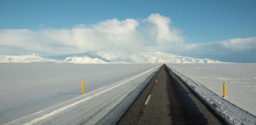 A beautiful shot of a narrow concrete road leading to a glacier
