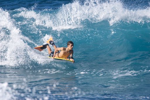 A young male surfer in the waves. Gran Canaria, Canary Islands.