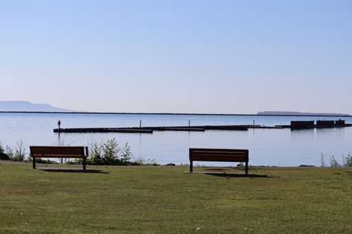 The two wooden benches overlooking a lake and distant mountains