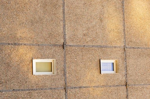 A vertical shot of a concrete building with windows