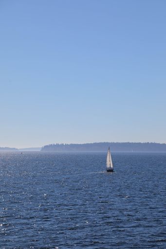 A small boat on the water near the shore in the early morning
