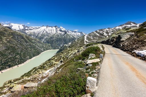 A scenic alpine road in the Bernese Alps with Lake Grimsel on the left, Switzerland