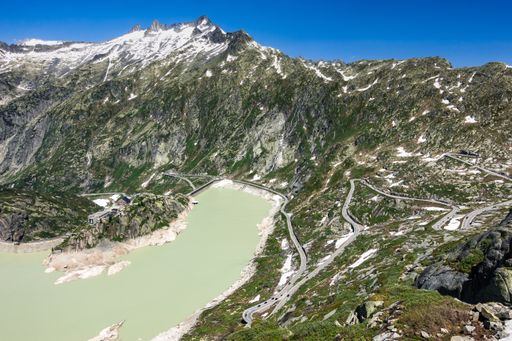 An aerial view of Lake Grimsel, Hospice and the serpentine road to Grimsel Pass in Switzerland