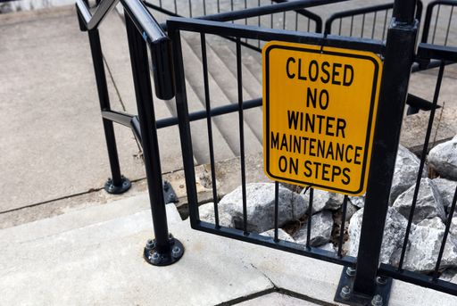 A closeup shot of a red closed sign on a black metal fence