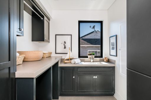 Modern white bathroom with sink, dishwasher, and drawers