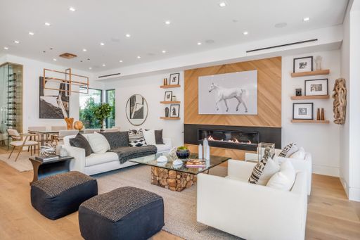 Cozy living room with fireplace, sofas, and table