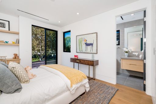 Stylish bedroom with neutral decor and wooden furnishings