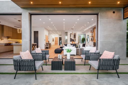 Living room with chairs and tables under skylight