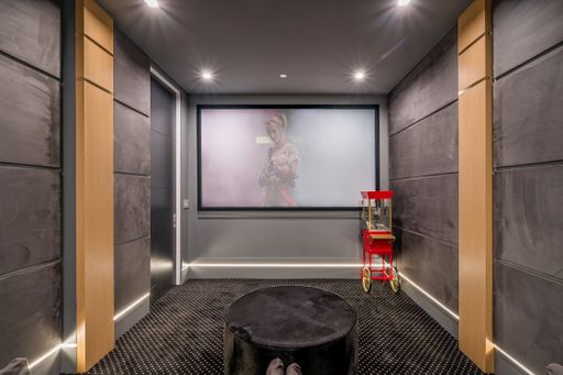 Interior of a cinema hall with a blank screen in motion on a wall