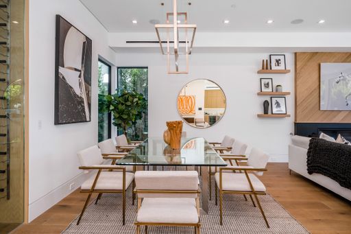 Contemporary dining set for eight people around glass table