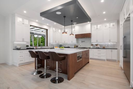 Modern kitchen with two bar stools by a marble countertop