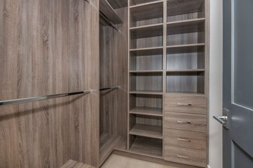 An open wooden closet with drawers in a modern new construction home in Los Angeles