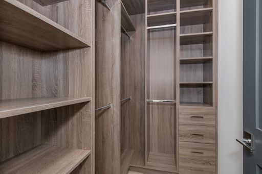 A neat walk-in closet with open shelving in a modern new construction home in Los Angeles