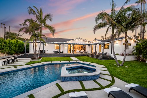 A backyard pool in a verdant garden setting in a modern new construction home in Los Angeles