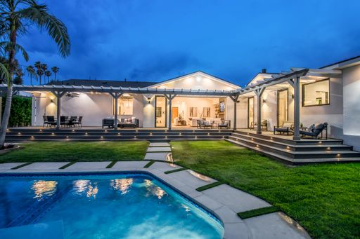 A backyard pool in a verdant garden setting in a modern new construction home in Los Angeles