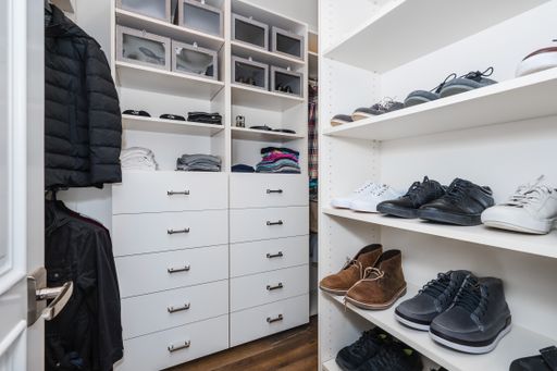 A wardrobe packed with various garments and shoes in a new construction home in Encino, California
