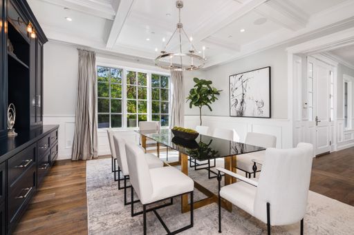A room with a table and chairs in a new construction home in Encino, California
