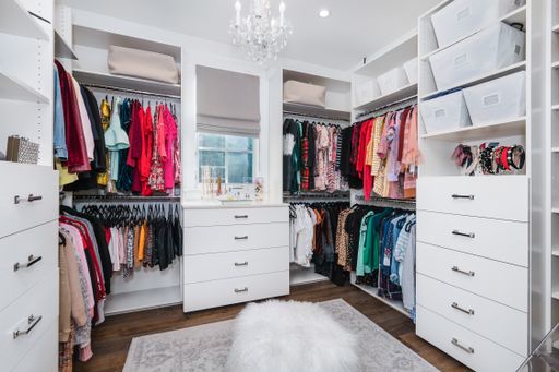 A wardrobe full of kids' clothing on shelves in a new construction home in Encino, California