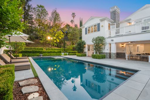 A swimming pool in front of a new construction home in Encino, California
