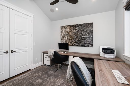 Modern office with desk, chair, and glass sliding door window