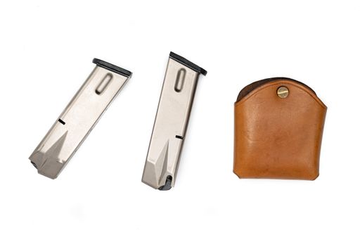 Detail of a leather holster and two magazines for a 9mm parabellum LLama semi-automatic pistol on a white background