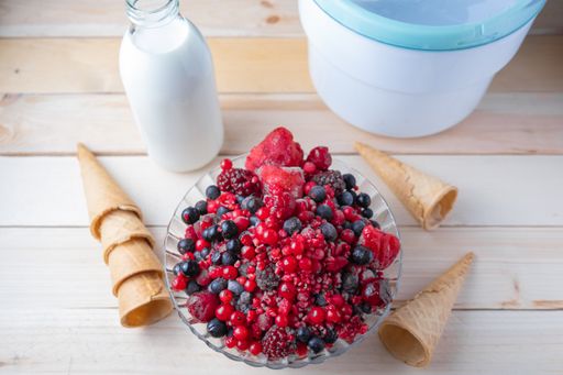 A top view of a wooden table with the ingredients to make homemade ice cream