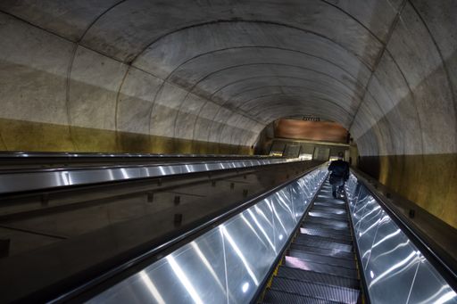 The man descending escalator into the Washington DC Metro