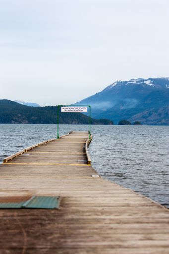 Wood jetty. Looking over water and mountains in the background