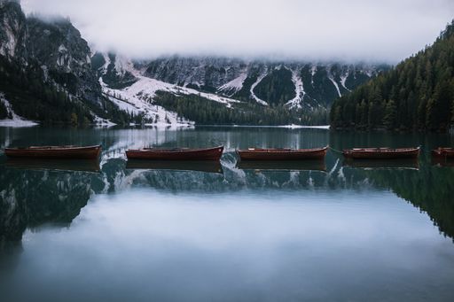 A beautiful cloudy autumn day with boats on Lake Braies captured in Mareo, Italy