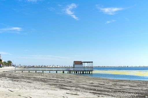 A view of a wooden jetty, at the coast at the Mar Menor, Spain.  The sea here is very calm and the beaches have fine sand.  A place to unwind.