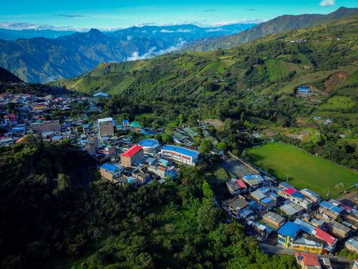 Aerial view of a small town encircled by mountains