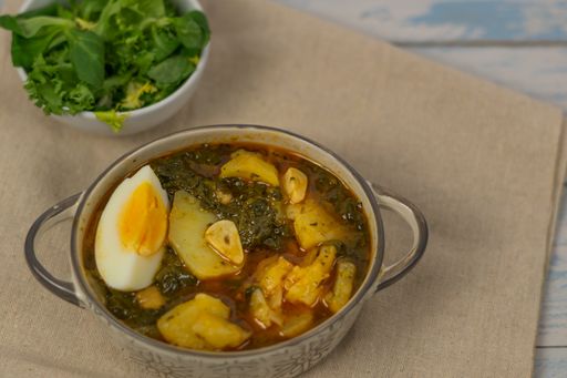 spinach casserole with potatoes on white background