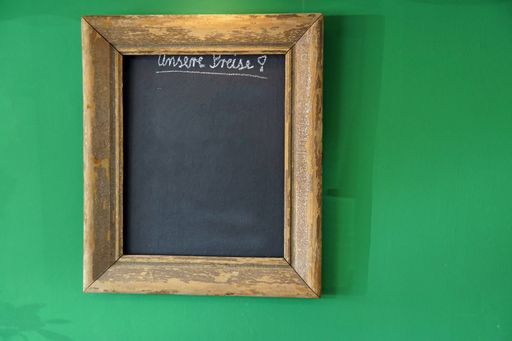 Wooden framed board hanging on green wall