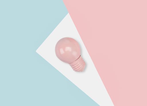 A light bulb on a colorful geometric background