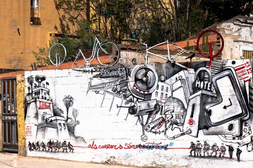 A mural showing a wall with paintings, and bicycles on top
