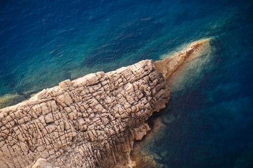 A beautiful shot of rocky cliffs of the sea on a sunny day