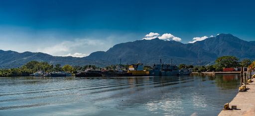 A wide angle shot of the water in front of the mountains