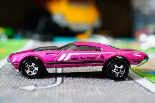 A selective closeup of a purple Mattel Hot Wheels toy model car