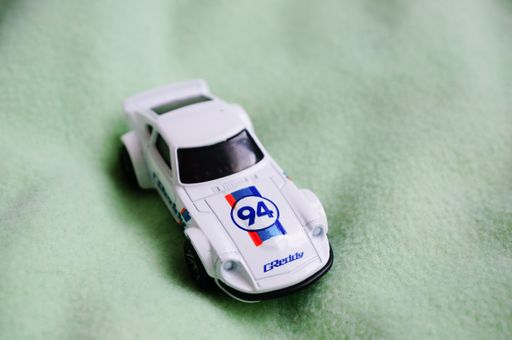 A selective closeup of a white Mattel Hot Wheels toy model Nissan Fairlady