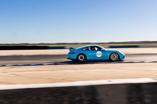 A blue Porsche racing on the track in Sebring, United States