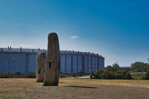 A stone sculpture in front of a building in Coruna, Galicia, Spain