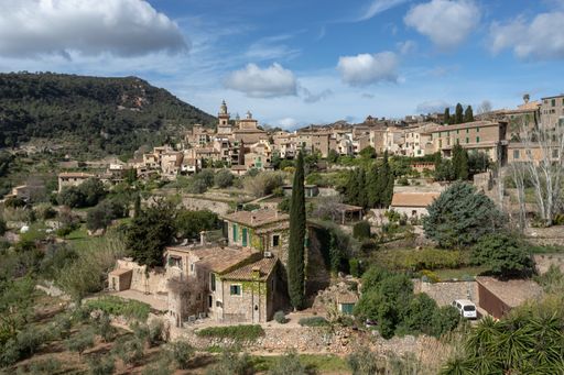 The scenic Valldemossa Town in Palma de Mallorca under a cloudy blue sky