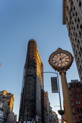 A low angle shot of Flat Iron building under blue clear sky New York City USA