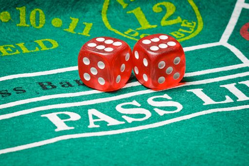 A closeup shot of two red dice playing poker in a casino